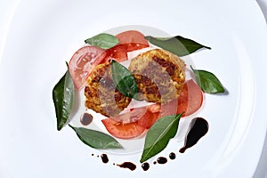 Vegetarian cabbage cutlets with tomatoes. decorated with fragrant leaves