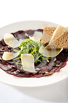 Vegetarian carpaccio with beetroot,nuts and toast