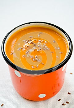 Vegetarian carrot-pumpkin cream soup with flax seeds