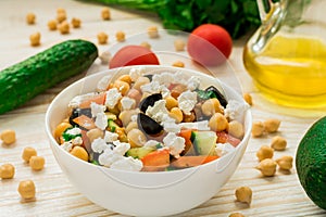 Vegetarian chickpea salad with olives, feta, tomatoes, onion and garlic