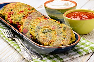 Vegetarian cuisine - vegetable fritters (with potatoes, carrot, zucchini, paprika and parsley).