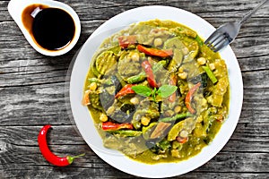 vegetarian curry with zucchini, eggplants, carrots, bell pepper, chickpeas, top-view