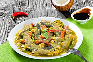 vegetarian curry with zucchini, eggplants, carrots, bell pepper, chickpeas, top-view