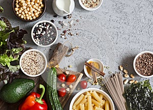 Vegetarian food background. Set of vegetarian products on the gray table, top view. Healthy, diet food concept.