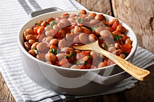 Vegetarian food Borlotti beans in tomato sauce with herbs close-up in a bowl. horizontal