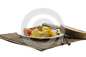 Vegetarian food with bread, on a white plate and on a rug