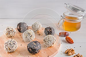 Vegetarian food, energy balls of walnuts, dates, prunes, cranberries, honey with sesame