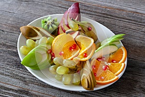 Vegetarian food: grapes, sliced oranges, apples and various frui