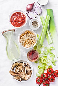 Vegetarian food ingredients for detox lunch. Soup ingredients - chicken broth, celery, leeks, lentils, chickpeas, tomatoes, red on