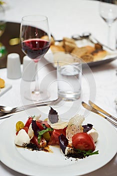 Vegetarian food with marinated tomatoes, arugula, mozzarella che