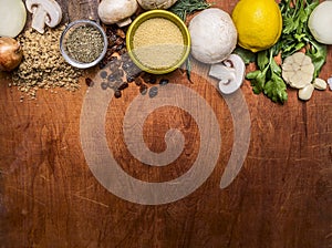 Vegetarian food pounded walnuts, lemon, mushrooms, vegetables, raisins wooden rustic background top view close up border ,place