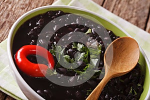 Vegetarian food: spicy black beans close up in a bowl. horizontal