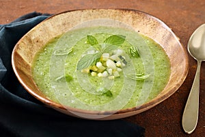 Vegetarian green cream soup in ceramic bowl