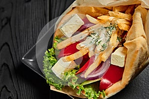Vegetarian gyro in pita with vegetables and tzatziki. Greek cuisine dish. healthy fast food. Close up