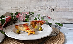 Vegetarian homemade pizza with mozzarella and olives on the white plate. Whitewood background.  Italian cuisine