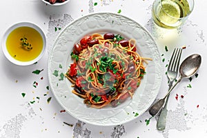 Vegetarian Italian Pasta Alla Puttanesca with garlic, olives, capers with on white plate.