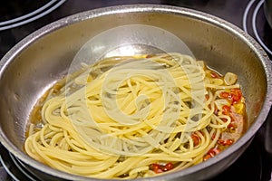 Vegetarian Italian Pasta Spaghetti Aglio E Olio with garlic bread, red chili flake, parsley, parmesan cheese.