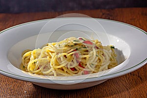 Vegetarian Italian Pasta Spaghetti Aglio E Olio with garlic bread, red chili flake, parsley, parmesan cheese.