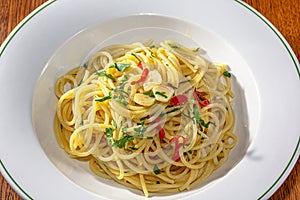 Vegetarian Italian Pasta Spaghetti Aglio E Olio with garlic bread, red chili flake, parsley, parmesan cheese.