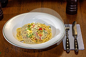 Vegetarian Italian Pasta Spaghetti Aglio E Olio with garlic bread, red chili flake, parsley, parmesan cheese.