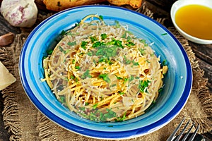 Vegetarian Italian Pasta Spaghetti Aglio E Olio with garlic bread, red chili flake, parsley, parmesan cheese and glas on