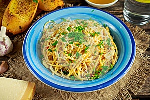 Vegetarian Italian Pasta Spaghetti Aglio E Olio with garlic bread, red chili flake, parsley, parmesan cheese and glas of