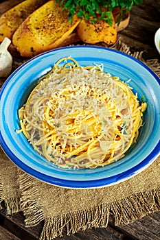 Vegetarian Italian Pasta Spaghetti Aglio E Olio with garlic bread, red chili flake, parsley, parmesan cheese and glas of water