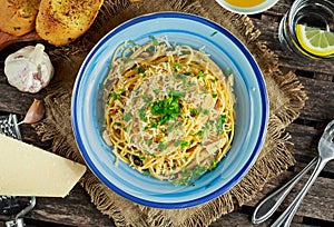 Vegetarian Italian Pasta Spaghetti Aglio E Olio with garlic bread, red chili flake, parsley, parmesan cheese and glas of water