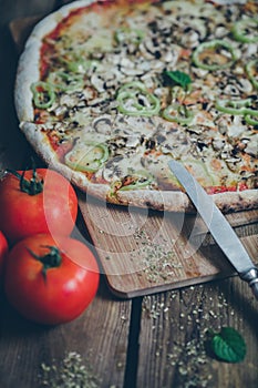 Vegetarian italian pizza on wodden table.