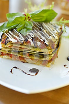 Vegetarian lasagna with tomato and pesto sauces