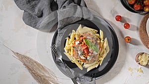 Vegetarian lentil Bolognese sauce penne pasta on a dark background. Healthy eating concept