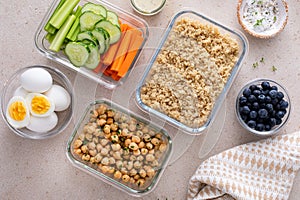 Vegetarian lunch meal prep in containers, high protein with quinoa, herbed chickpeas, vegetables and boiled eggs