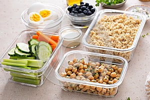 Vegetarian lunch meal prep in containers, high protein with quinoa, herbed chickpeas, vegetables and boiled eggs