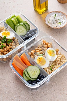 Vegetarian lunch meal prep containers high protein with quinoa, herbed chickpeas, vegetables and eggs