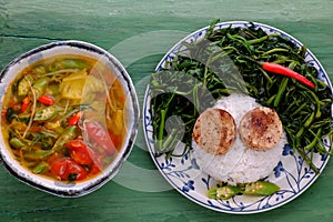 Vegetarian meal, rice dish with boiled water morning glory, vegan sausage, sour soup bowl