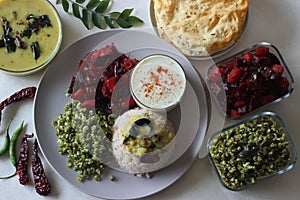 Vegetarian meals prepared in Kerala style. The serving includes boiled red rice, lentil curry, stir fried beetroot and potato,