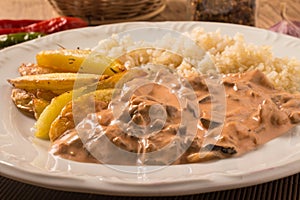 Vegetarian Mushroom Stroganoff with rice and rustic potatoes.