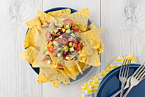 Vegetarian nachos with salsa and sour cream dips