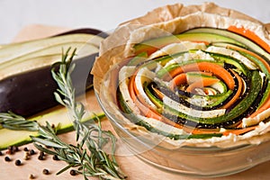 Vegetarian pie with eggplants, carrots, squash, zucchini, pepper and rosemary.