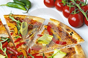 vegetarian pizza with cheese, tomato, pepper and avocado in white