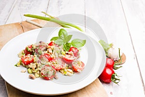 Vegetarian Quinoa salad dish on white wooden background