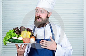 Vegetarian salad with fresh vegetables. Healthy food cooking. Mature hipster with beard. surprised bearded man. chef