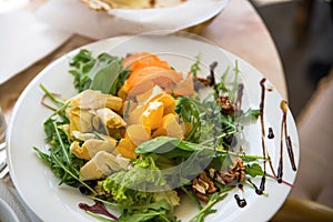 Vegetarian salad with fruit,lettuce, vegetable and walnut.