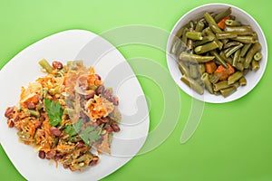 Vegetarian salad. Healthy food. Salad of beans, asparagus, onion, carrot and sesame on a plate on a wooden background