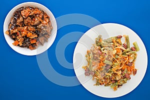 Vegetarian salad. Healthy food. Salad of beans, asparagus, onion, carrot and sesame on a plate on a wooden background