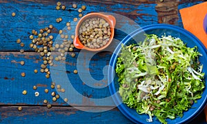 Vegetarian salad with lettuce and lentil. Colorful blue orange background