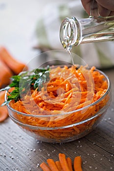 vegetarian salad with raw carrot pouring oil