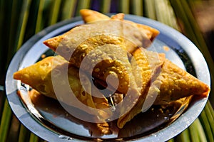 Vegetarian samosas, Indian special traditional street food. Indian stuffed snacks Samosa on metal plate, close up