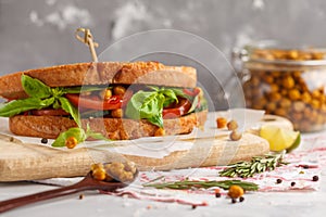 Vegetarian sandwich with tomato, cucumber, fried chickpeas and b