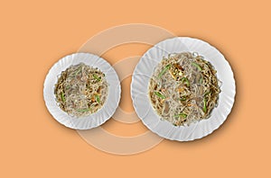 Vegetarian Schezwan Noodles or Vegetable Hakka Noodles or Chow Mein in white plate at wooden background. Schezwan Noodles is indo-